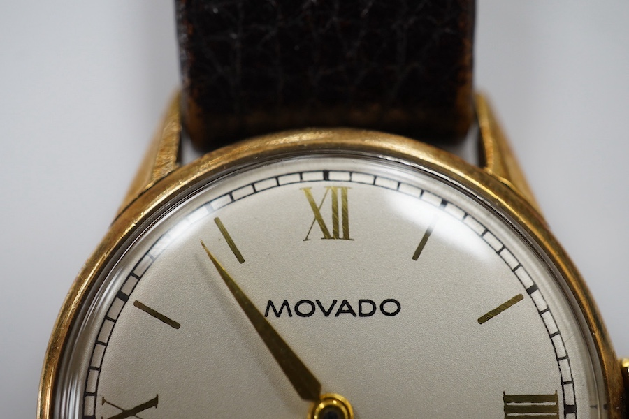 A gentleman's late 1930's 9ct gold Movado manual wind wrist watch, with baton and quarterly numerals and subsidiary seconds, case diameter 29mm, on an associated leather strap. Condition - fair